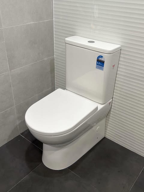 New toilet installed in a tiled bathroom